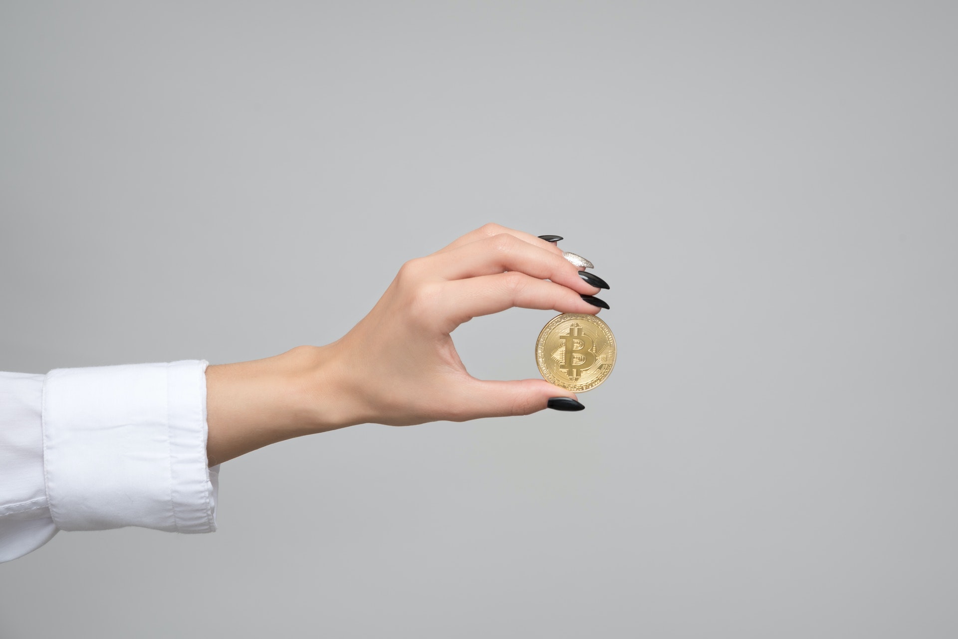 Woman holding a bitcoin in her hand